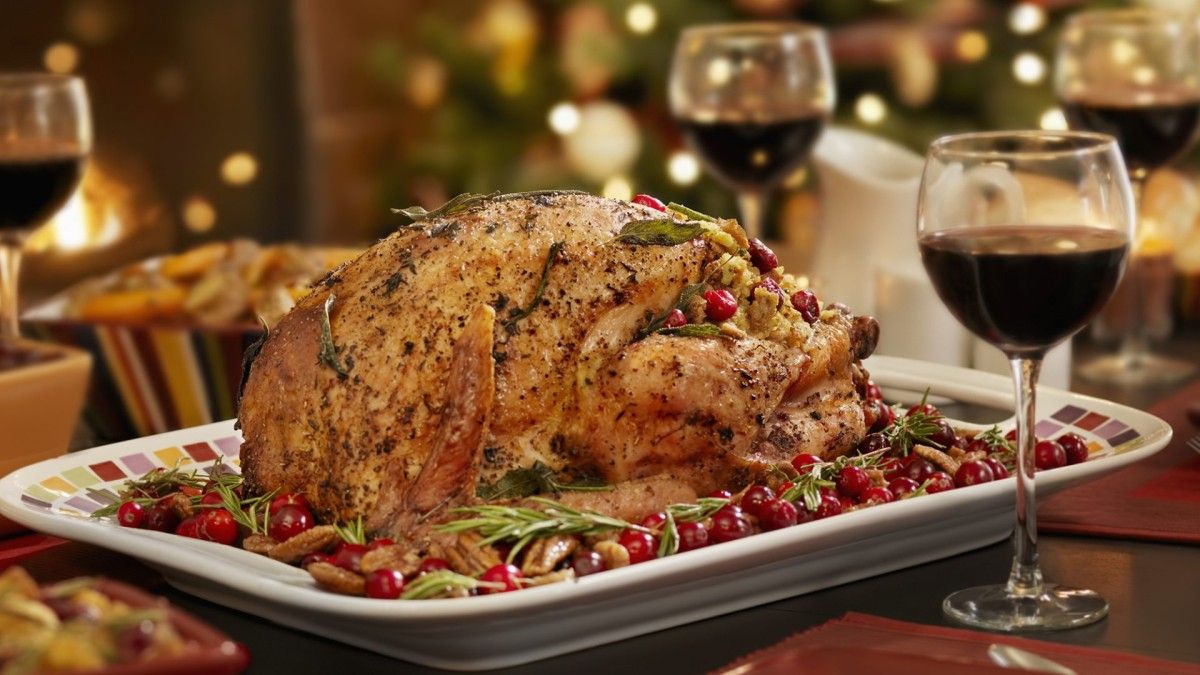 Roasted turkey on a holiday table with glasses of Zinfandel