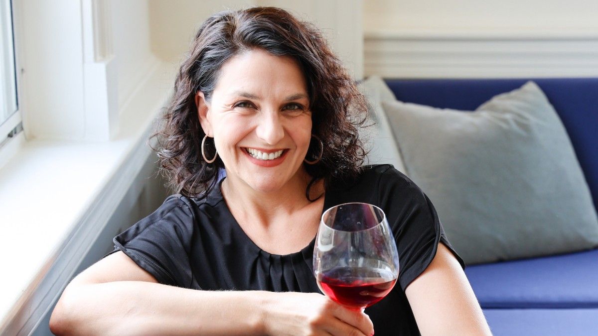 Elizabeth Schneider relaxes for a chat with a glass of wine