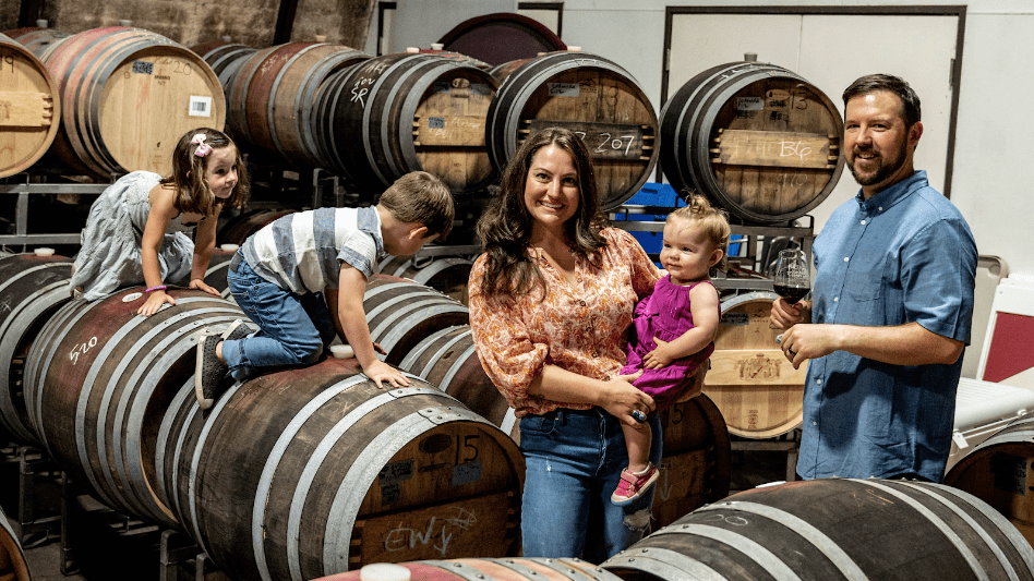Andrew and April Nalle of Sonoma's Nalle Winery enjoy time in the winery's barrel room with their three children.