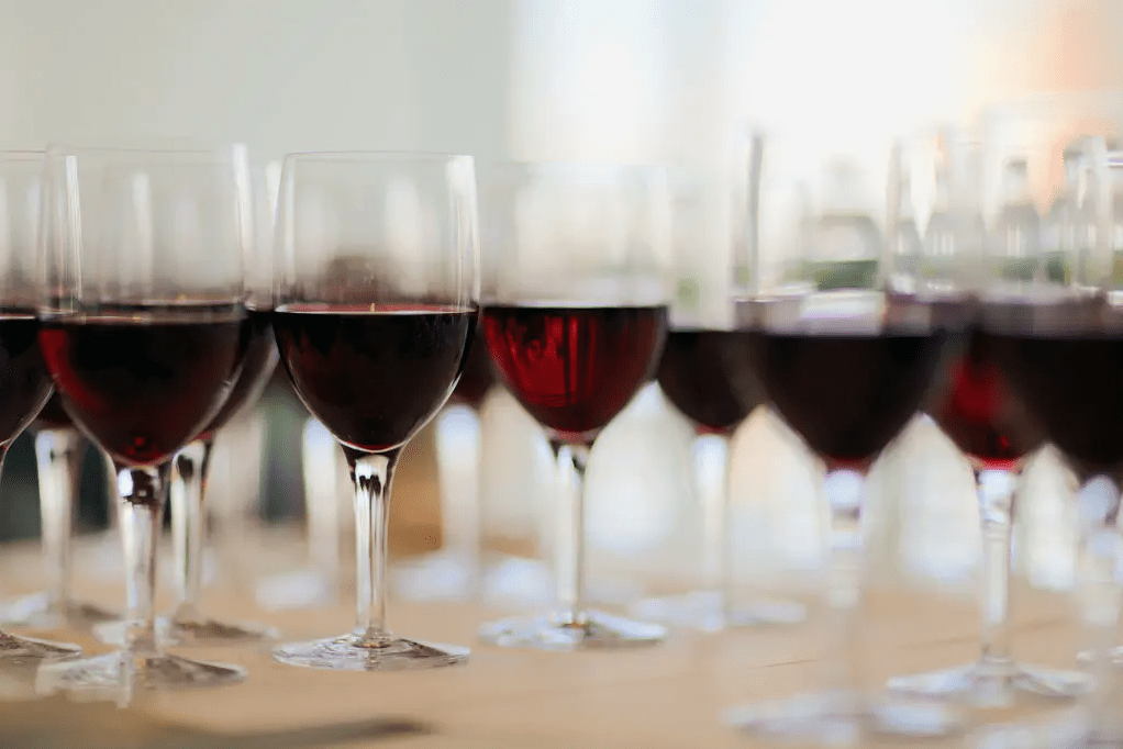 Wine glasses full of red wine